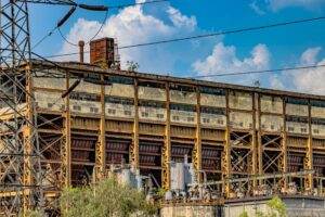 A dramatic view of an abandoned industrial structure in Delhi, India under a vibrant sky.