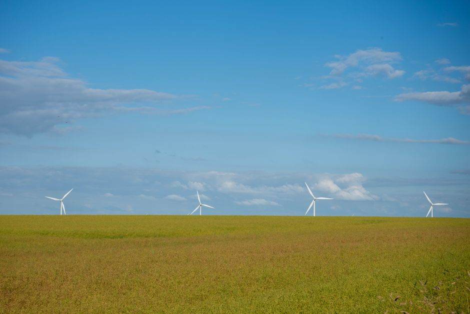 Wind turbines in a rural landscape near a small French village