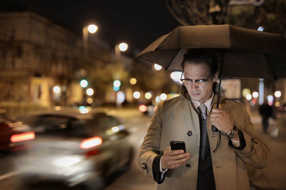 Person using smartphone in a busy Paris street with fast mobile internet