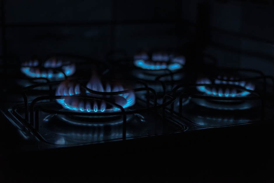 Gas flame on a kitchen stove with blue flames