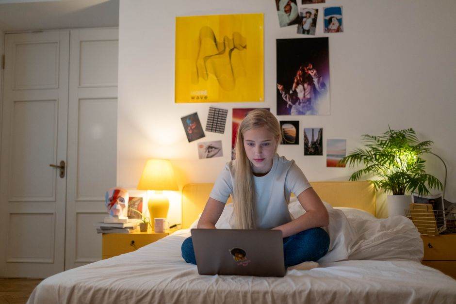 Young person studying for driving theory on a laptop with online learning platform