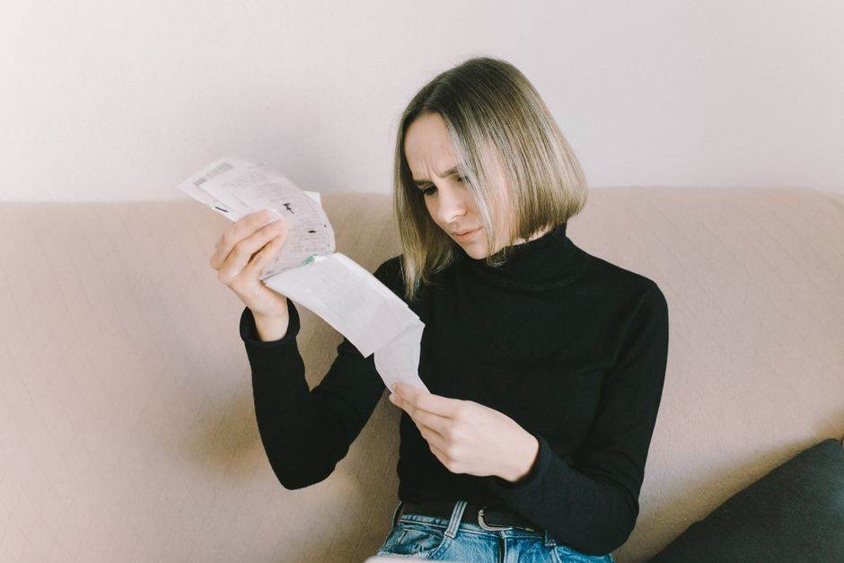 Person reviewing household bills and budget on a table