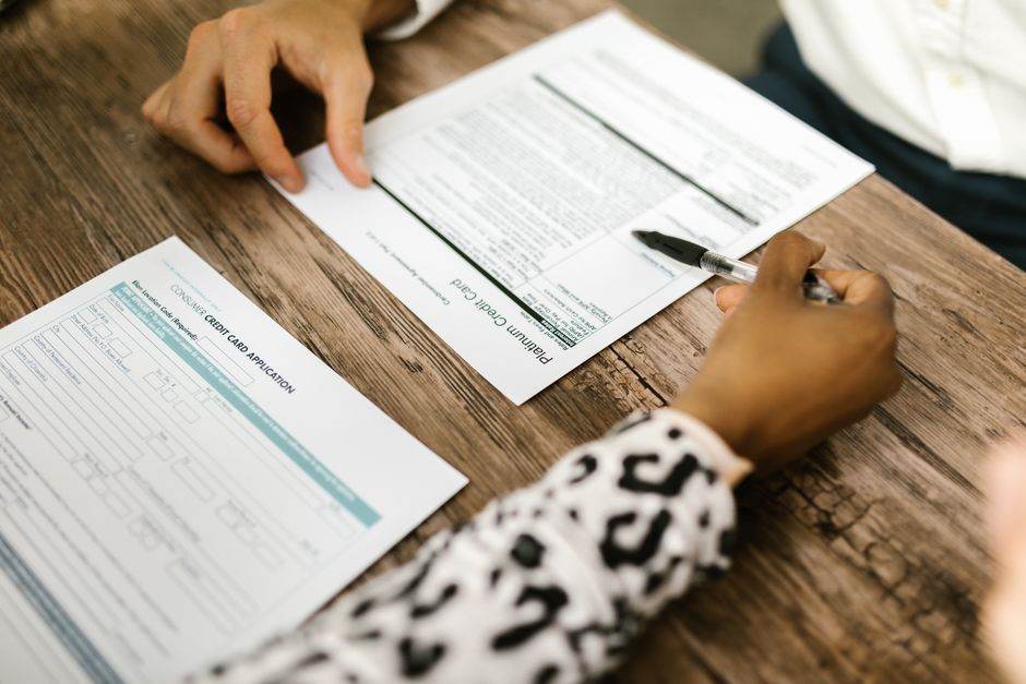 Person reviewing contract terms on a desk with documents