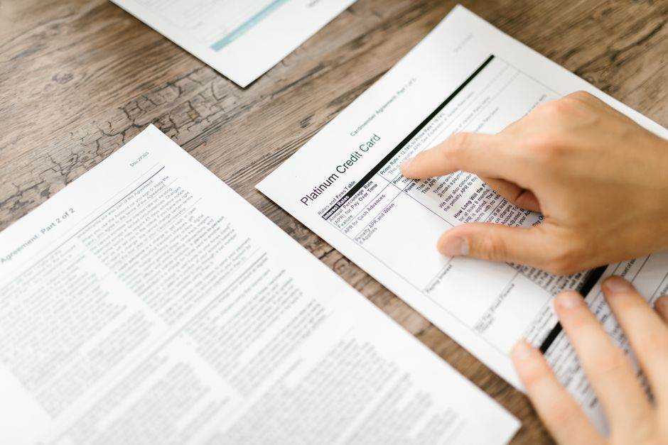 Customer comparing electricity bills and contracts at home
