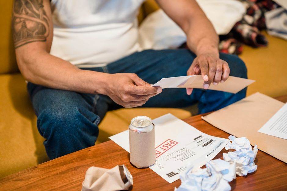 Envelope with energy bill and government aid paperwork on a kitchen table