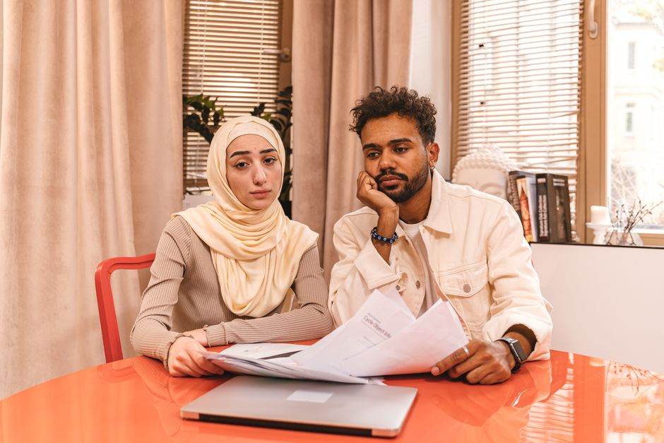 Family reviewing bills at a kitchen table