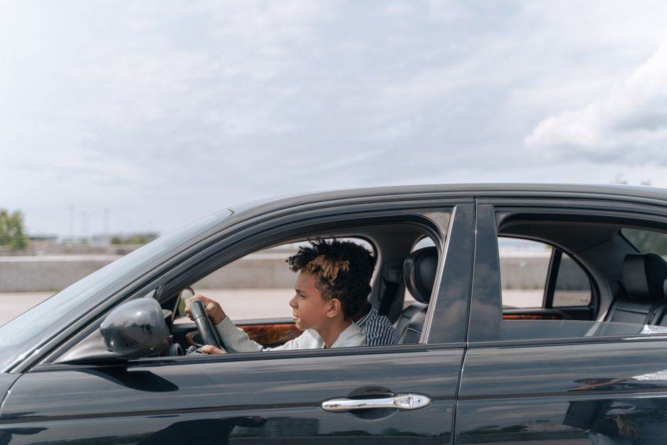 Young driver in a small city car on an urban street