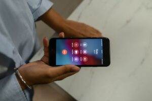 Close-up of a person holding a smartphone displaying an incoming call screen.