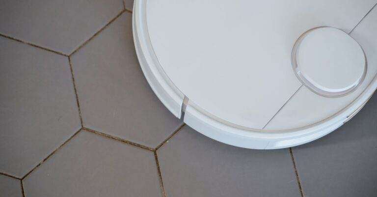 Close-up of a robotic vacuum cleaner on hexagonal tiles for efficient cleaning.