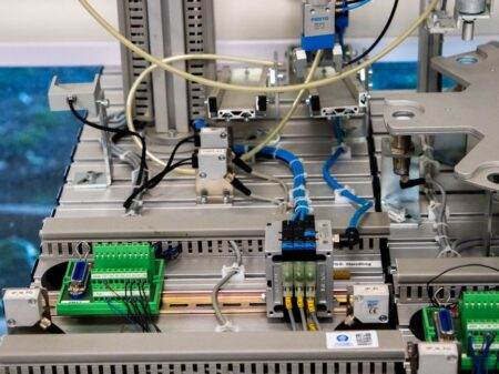 Papier intelligent en 2026 : capteurs, matériaux et carnet numérique Close-up of industrial equipment showcasing electronic wiring and sensors in a manufacturing setup.