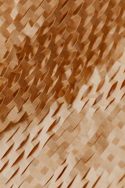 Detailed close-up of a geometric and textured brown paper pattern with a warm and artistic touch.