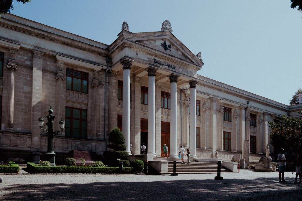 Exterior view of Istanbul Archaeology Museum showcasing neoclassical architecture bathed in daylight.