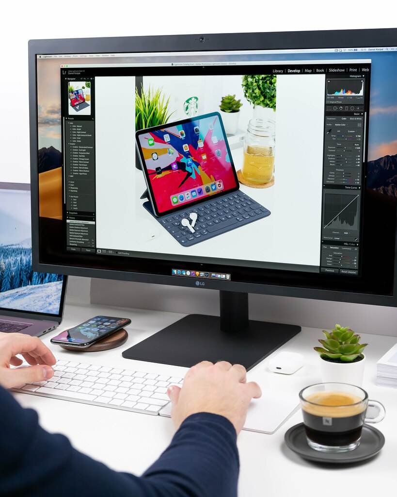 person using computer setup on white desk - Credit to https://myfriendscoffee.com/