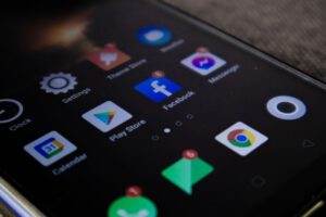Detailed view of a smartphone screen with popular app icons including Facebook and Messenger.