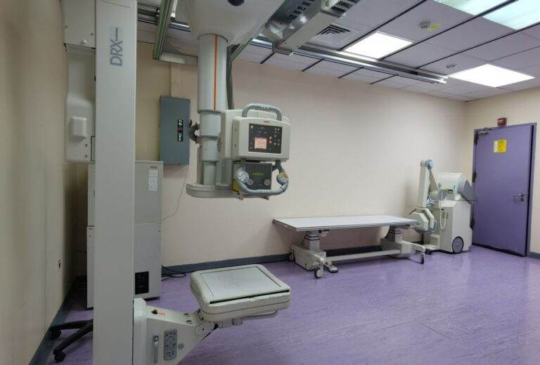 Hôpitaux américains : l’imitation des services a ses limites Interior view of a well-equipped hospital X-ray room with medical imaging devices.