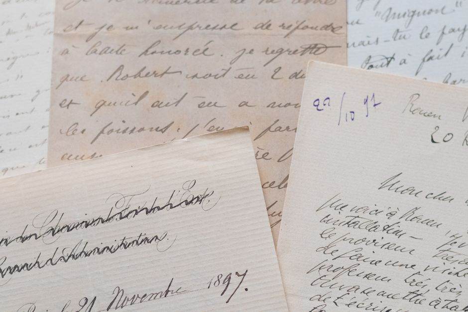 A collection of vintage handwritten letters in French, showcasing elegant cursive calligraphy on aged paper.
